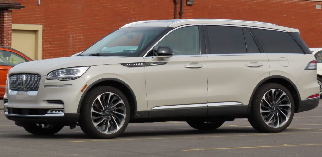 2020 Lincoln Aviator Reserve AWD in Ceramic Pearl, viewed from the front left in a parking lot.